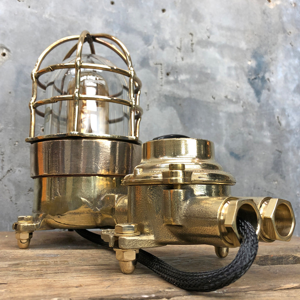 A vintage industrial cast bronze and brass explosion proof table lamp with an isolator switch