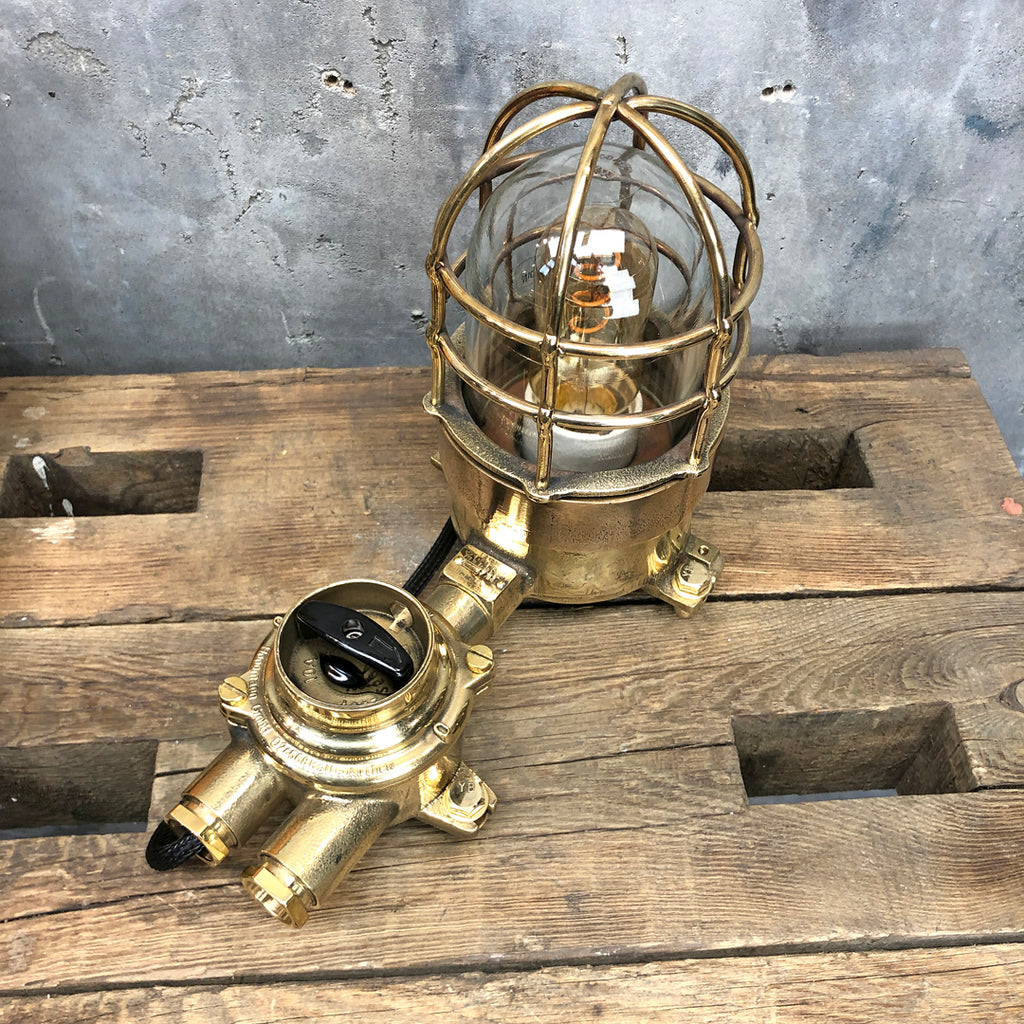 A vintage industrial cast bronze and brass explosion proof table lamp with an isolator switch