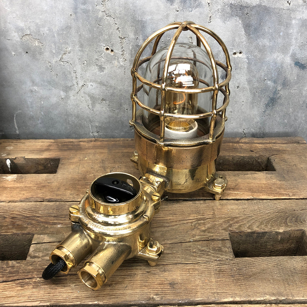 A vintage industrial cast bronze and brass explosion proof table lamp with an isolator switch