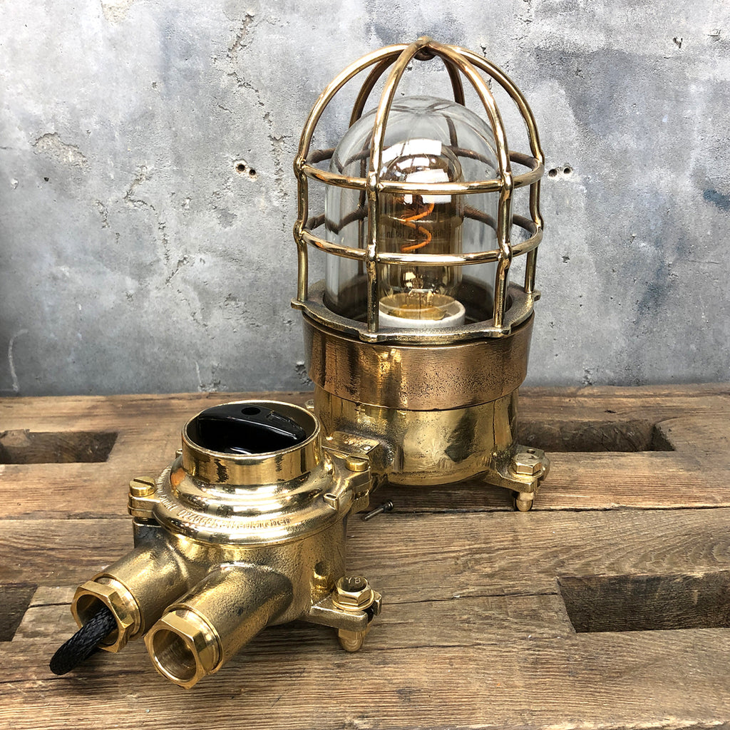 A vintage industrial cast bronze and brass explosion proof table lamp with an isolator switch