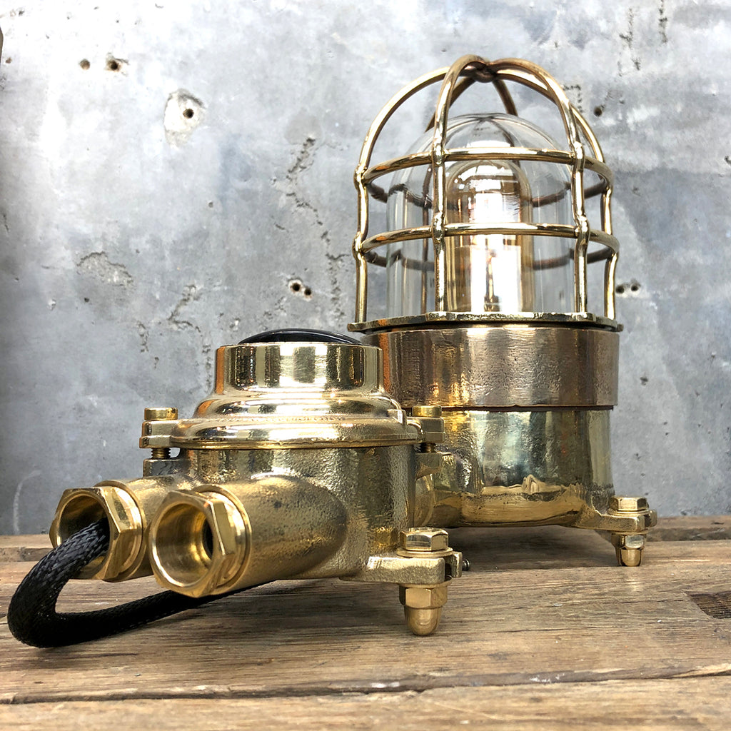 A vintage industrial cast bronze and brass explosion proof table lamp with an isolator switch