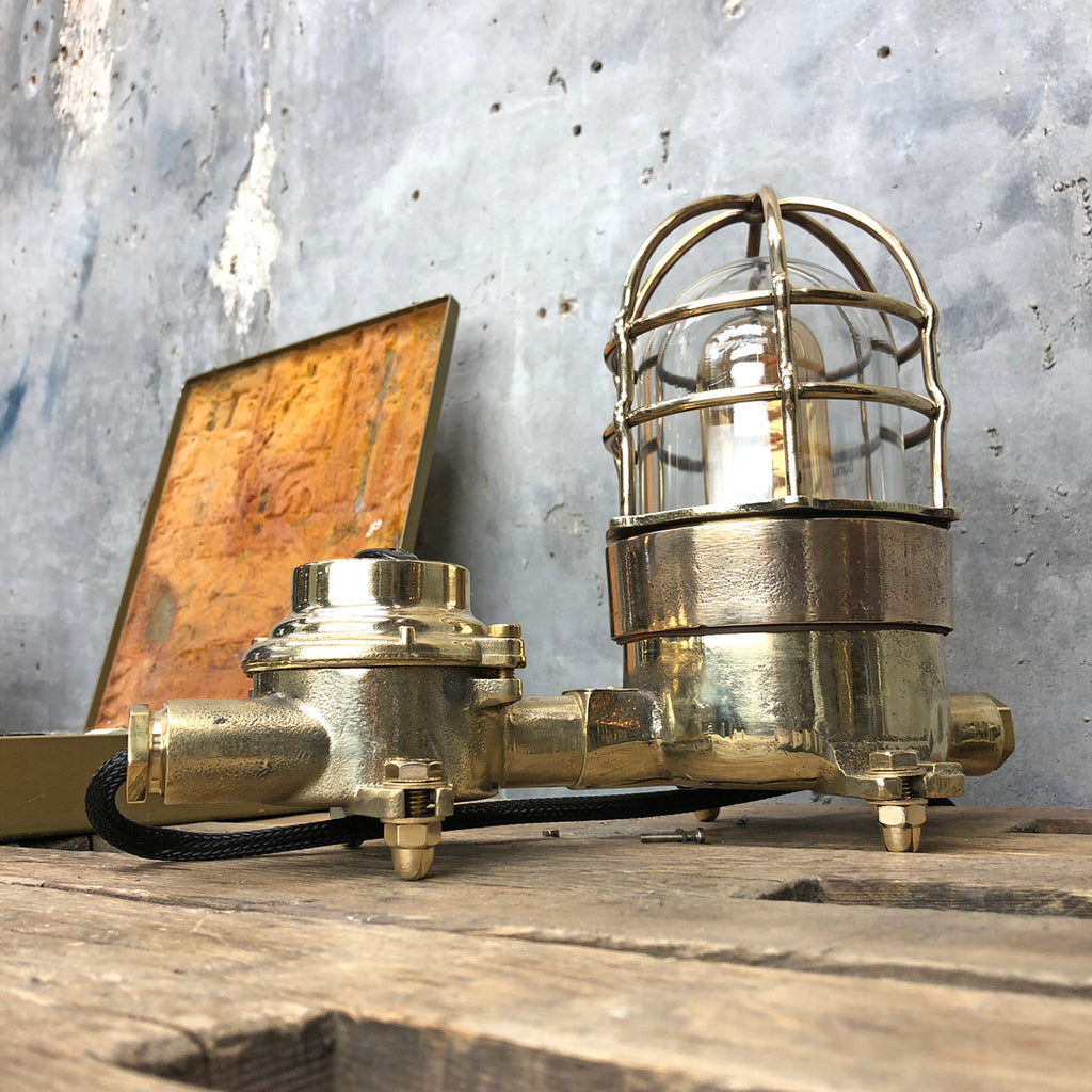 A vintage industrial cast bronze and brass explosion proof table lamp with an isolator switch
