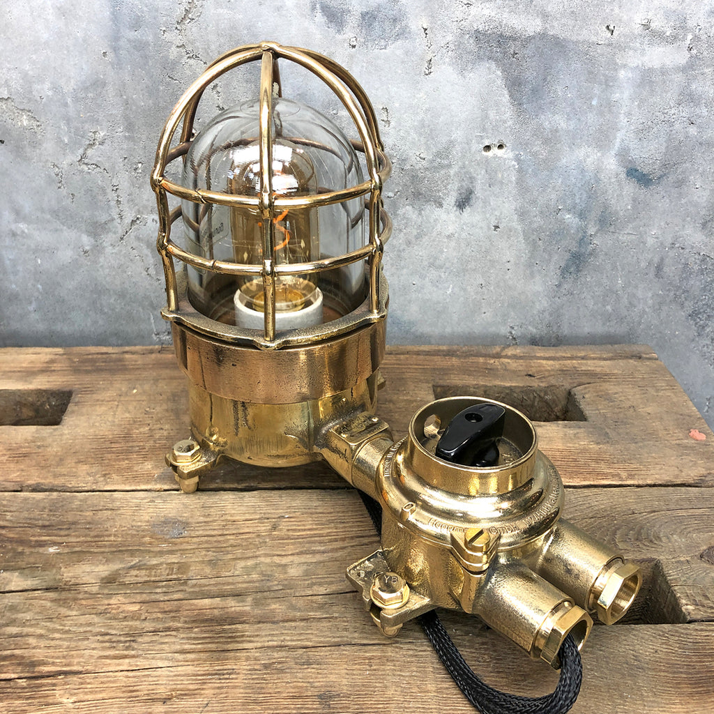 A vintage industrial cast bronze and brass explosion proof table lamp with an isolator switch